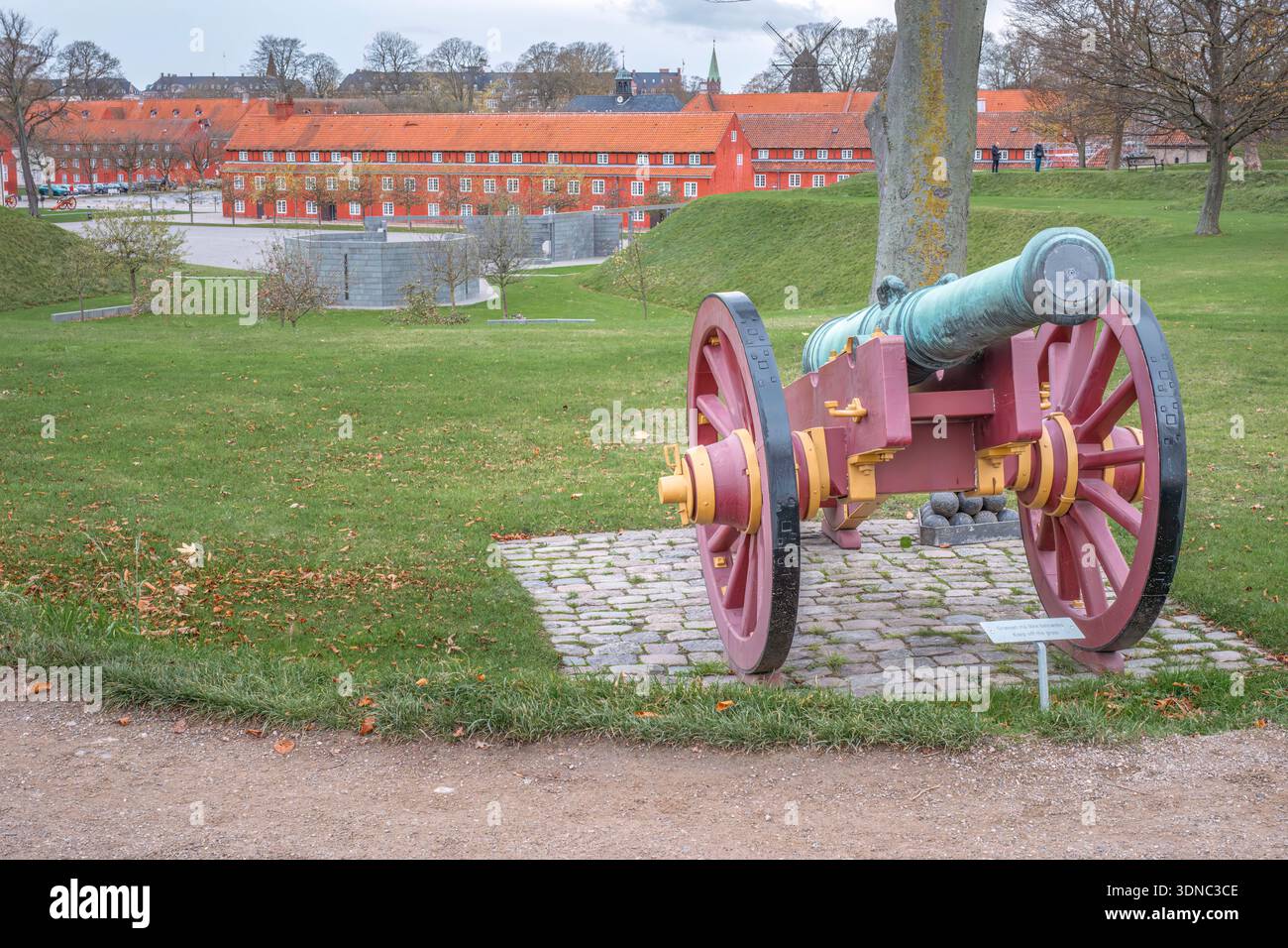 Ancient Cannon at Kastellet Fortress, , Red Barracks in Background, Star-Shaped, Copenhagen, Denmark Stock Photo
