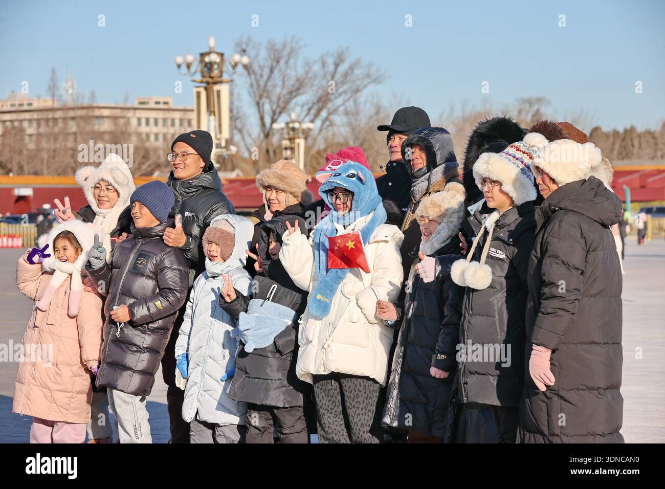 Tourists bundle up against freezing winds while visiting Tiananmen ...