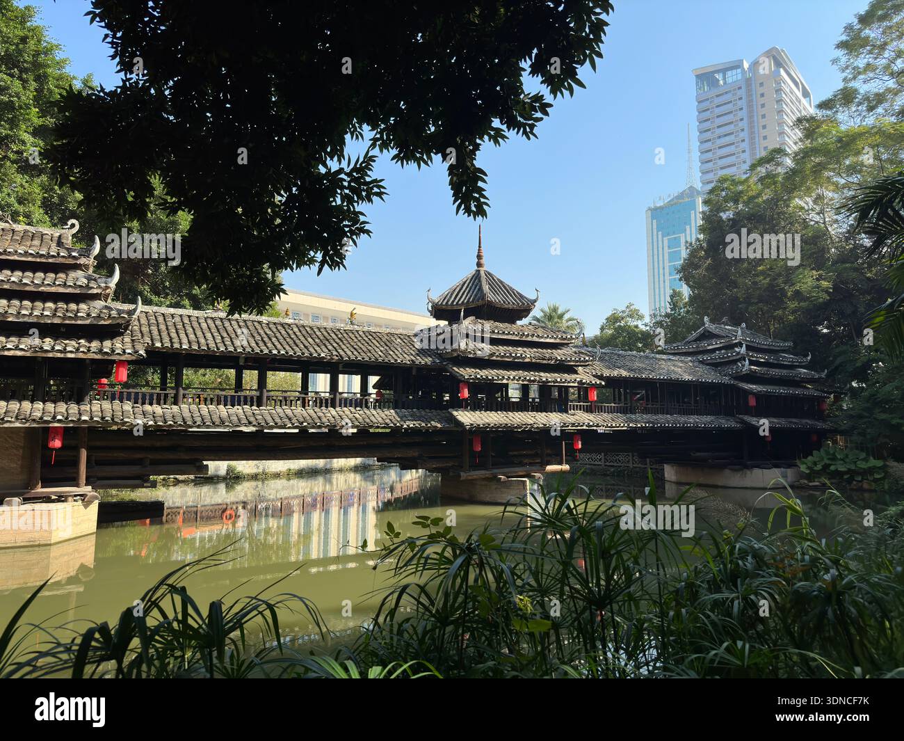 Ancient Chinese covered bridge with traditional architecture reflected in Nanning, Guangxi, China. - Smartphone Captured Stock Image