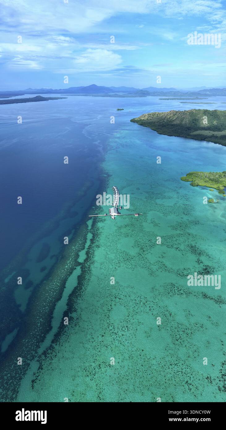 Aerial view of turquoise waters meet the deep blue sea, revealing ...