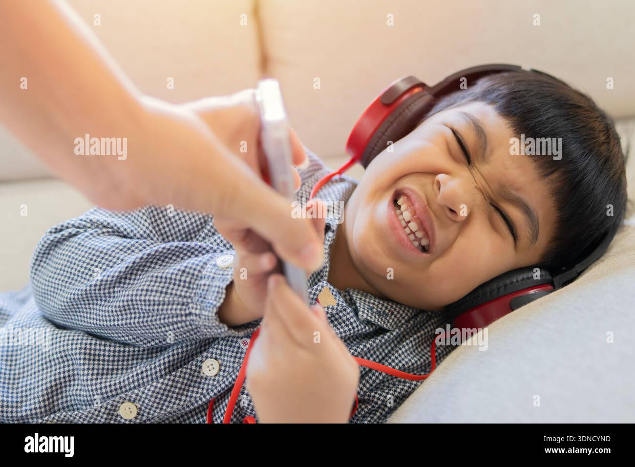 Child reaching for smartphone from parent, screen time control, tech addiction in kids, cartoon watching, modern family, children addicted to mobile p Stock Photo