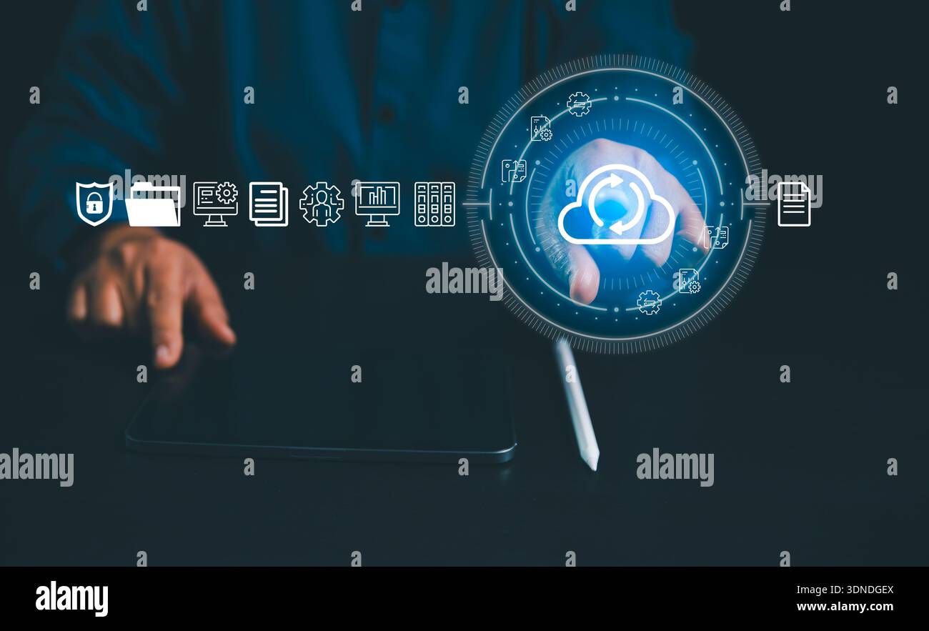 Businessman touching cloud sync icon on virtual interface with documents and server symbols, representing cloud storage, backup, secure data managemen Stock Photo