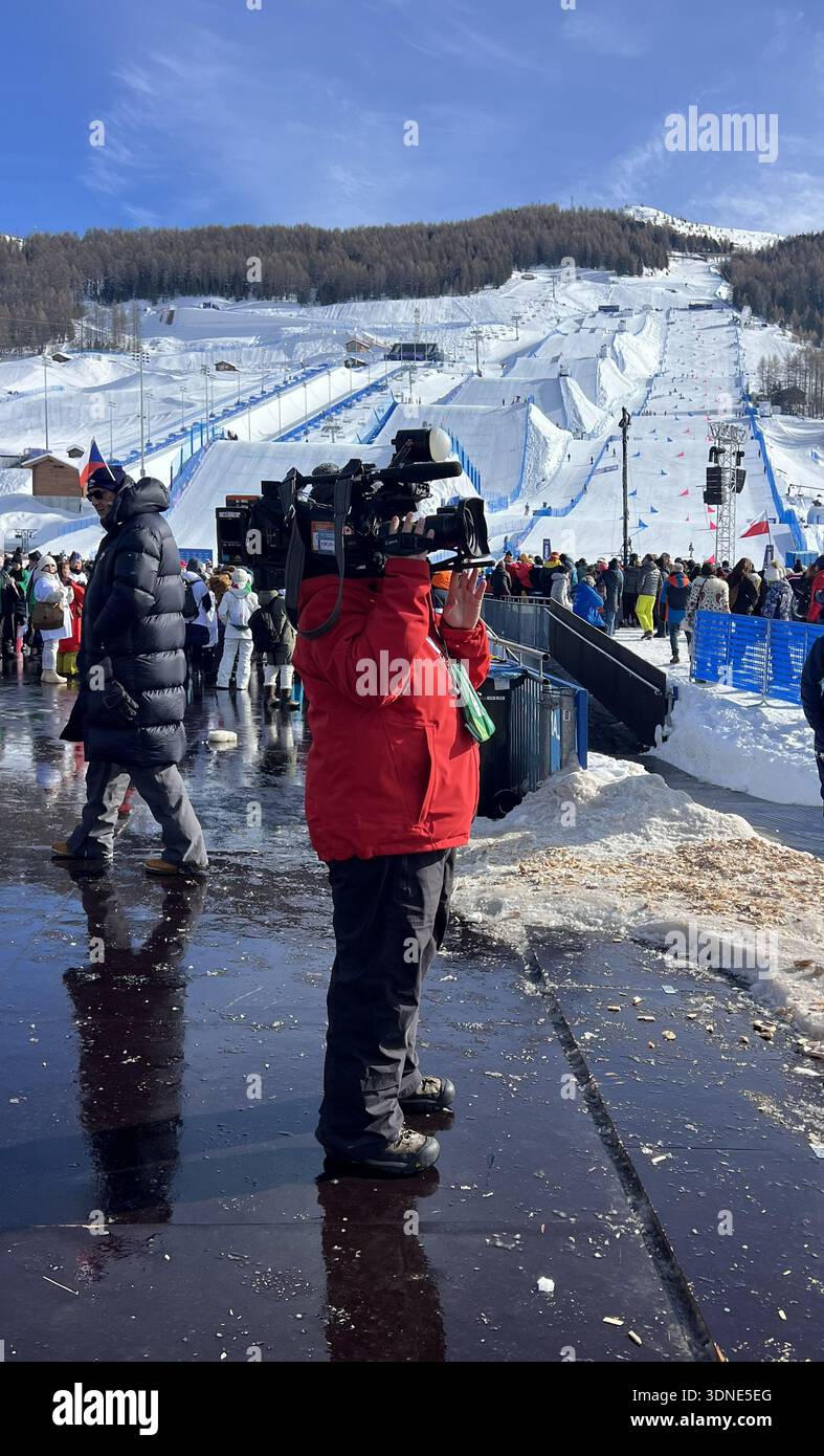 Space Ramps Italy Livigno, Italy - February 8, 2026: Cameraman filming freestyle big air ...