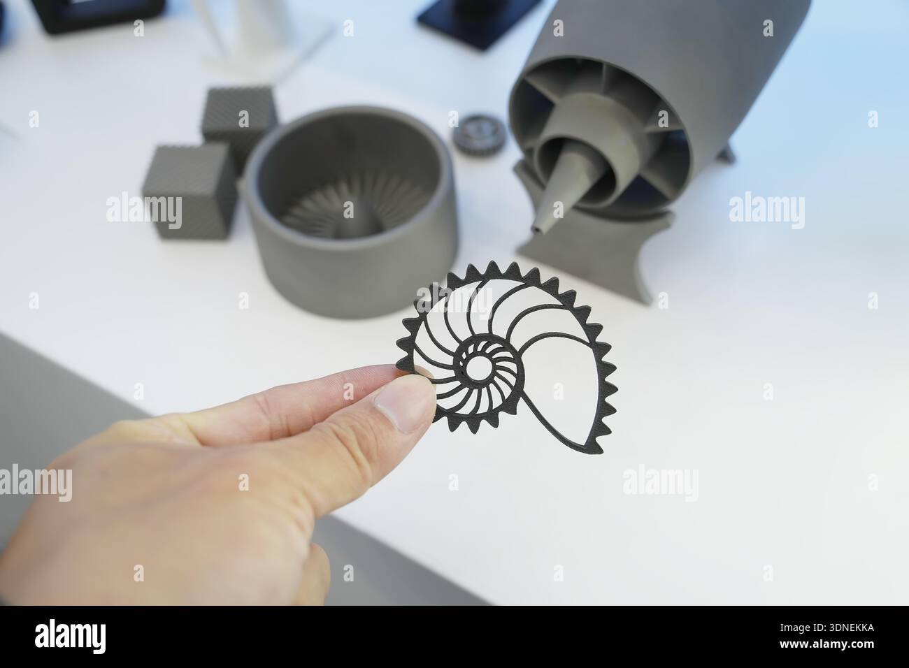 hand with metal shell object printed on 3d printer close-up Stock Photo