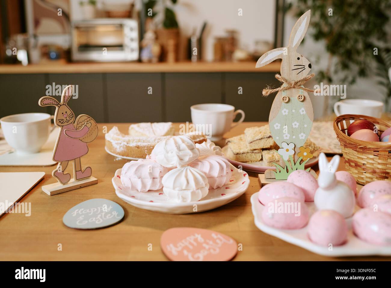 Easter Table Setting Featuring Decorative Bunnies and Festive Sweets Stock Photo