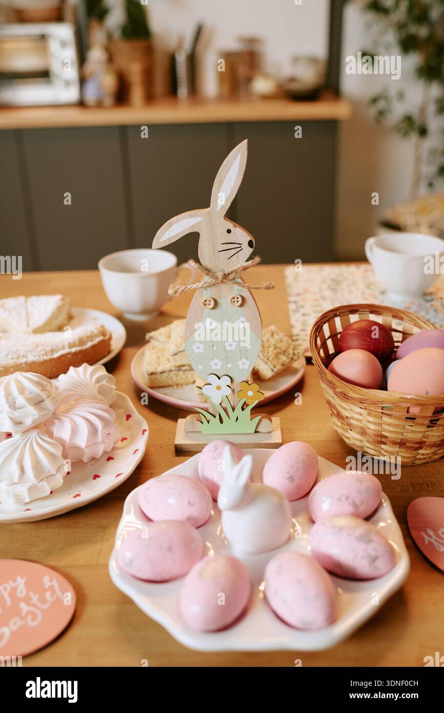 Easter Table Displaying Painted Eggs and Pastries during Spring Celebration Stock Photo