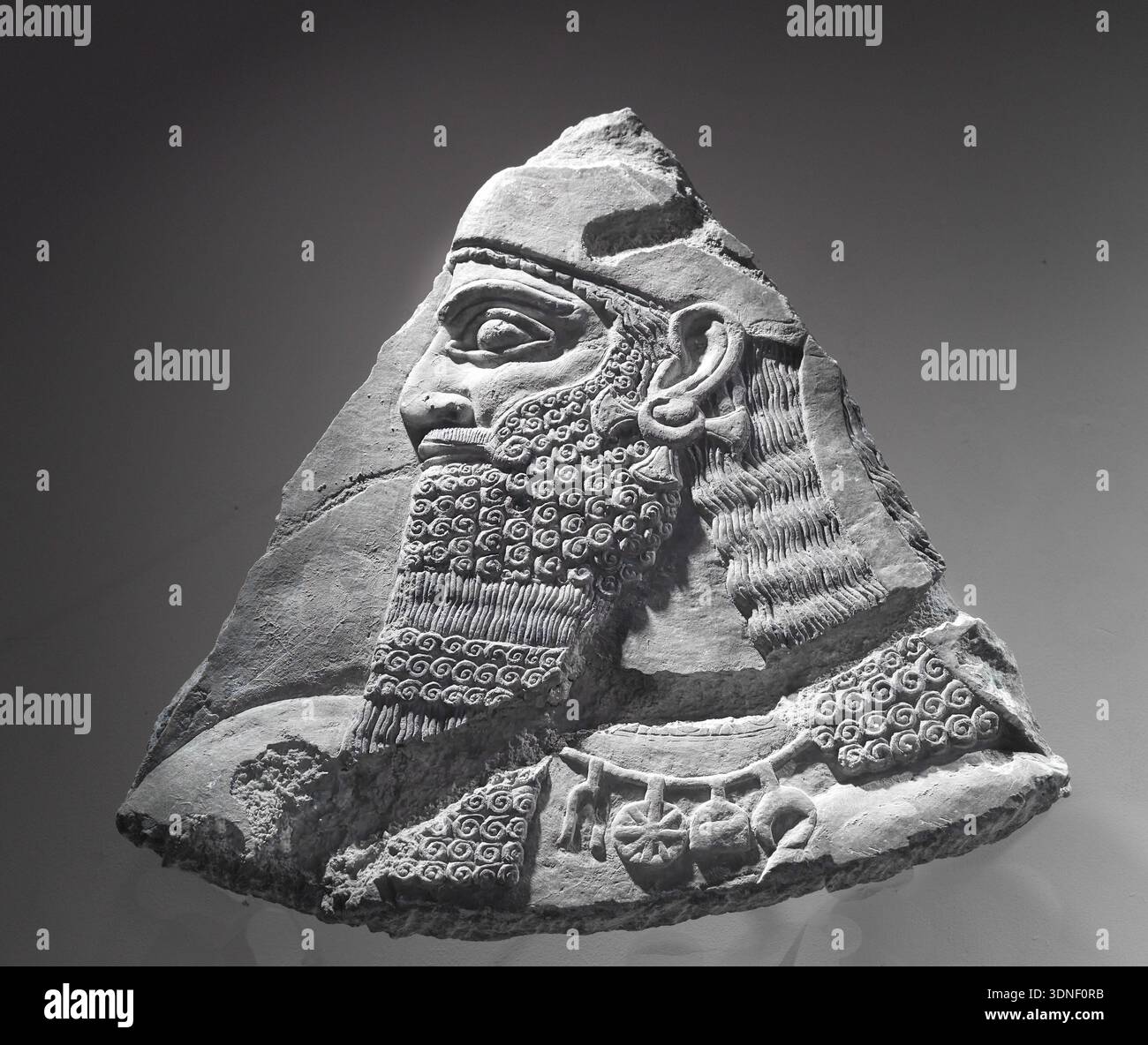 Assyrian fragment of a king or god, ninth century BC, Fitzwilliam Museum, University of Cambridge, England. Stock Photo