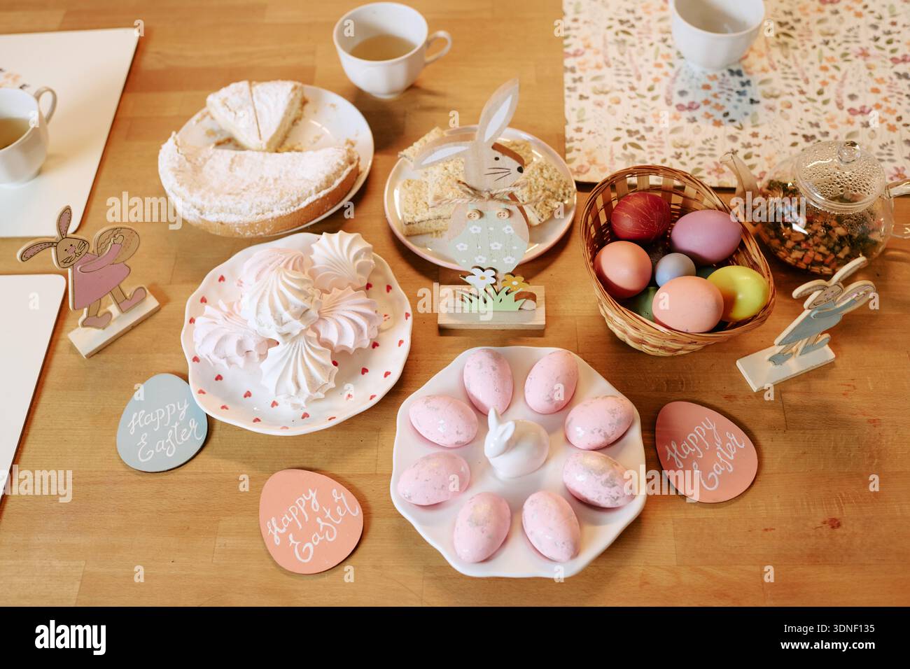 Easter Table Setting Featuring Painted Eggs and Festive Holiday Desserts Stock Photo