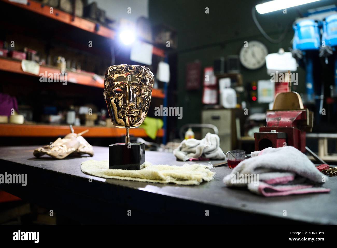 A completed British Academy Film Awards mask sits on a workbench at the ...