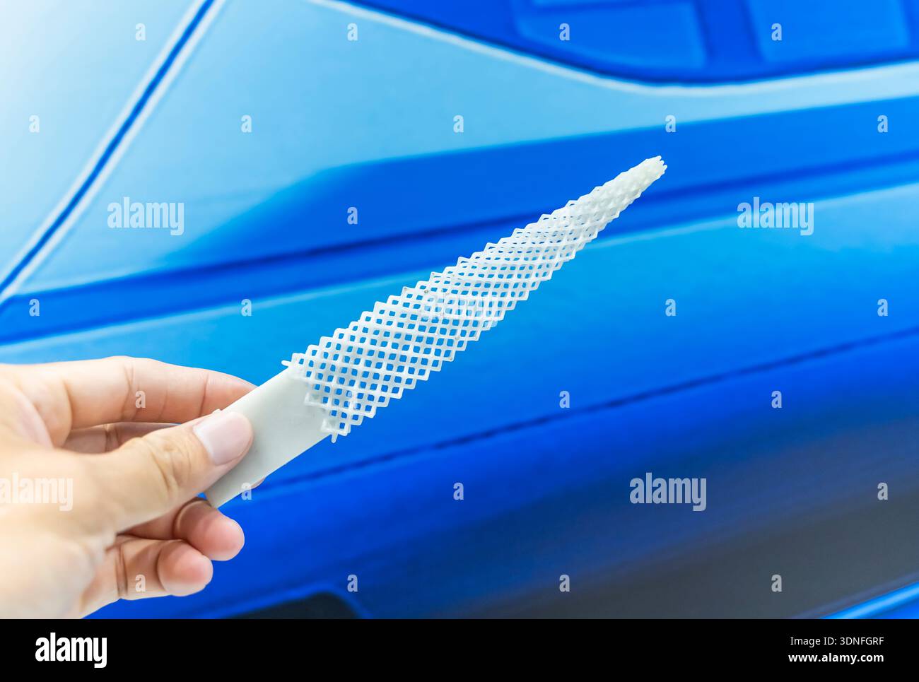hand with flexible object printed on 3d printer close-up Stock Photo