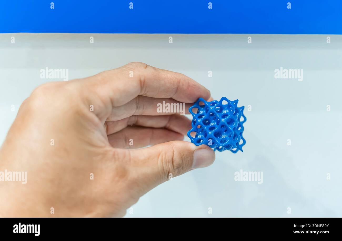 hand with flexible object printed on 3d printer close-up Stock Photo