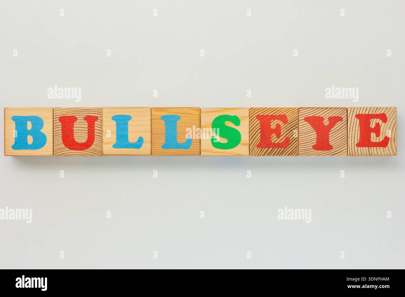 Brightly colored wooden letter blocks forming the phrase Bullseye Stock Photo