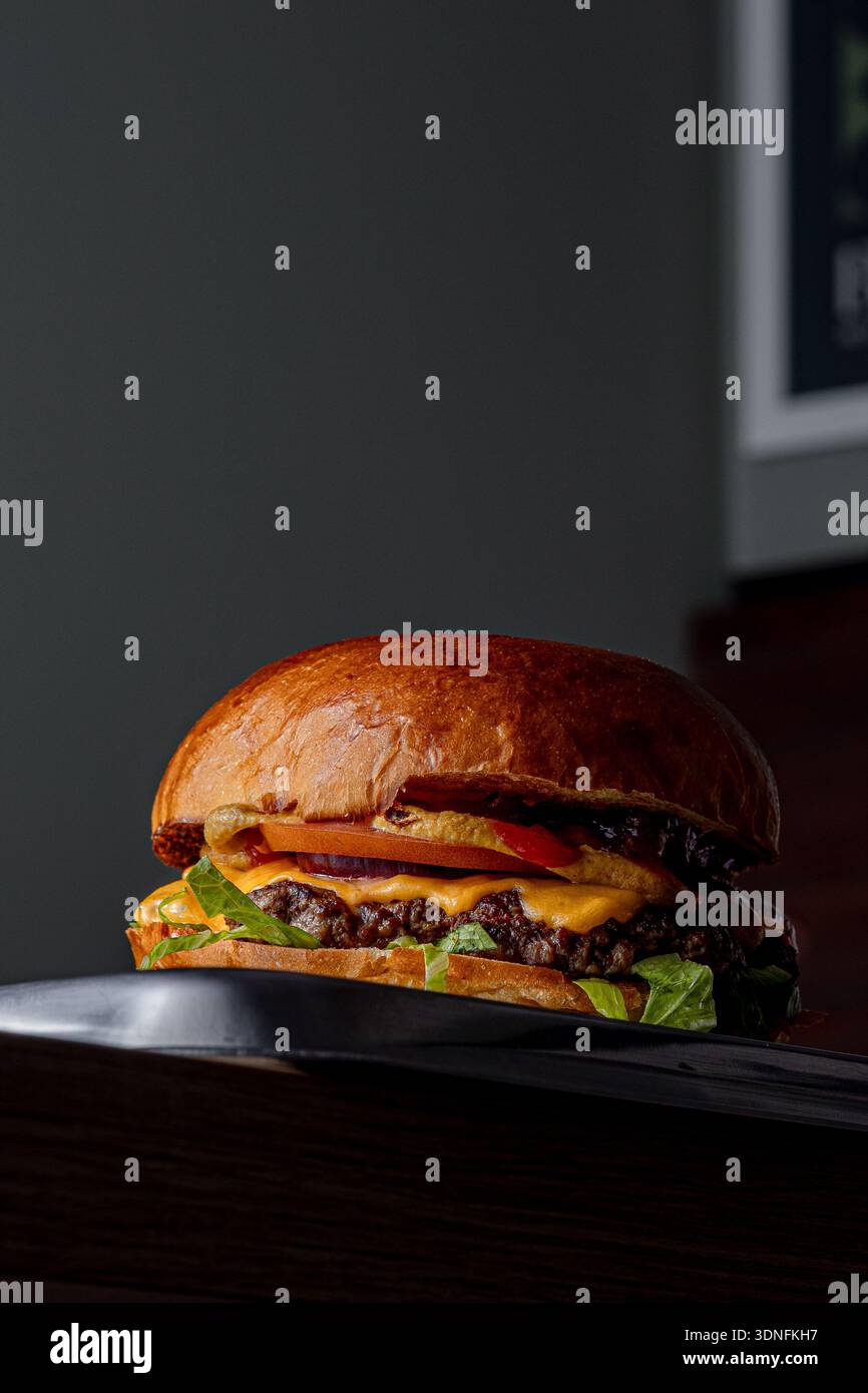 Burger on a dark background isolated with space for text Stock Photo