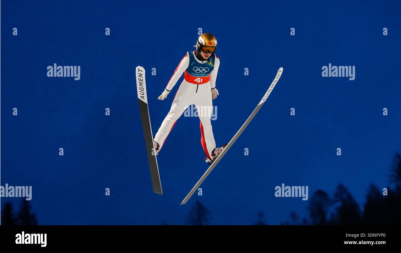 Zeng Ping, of China, soars through the air during the ski jumping mixed ...