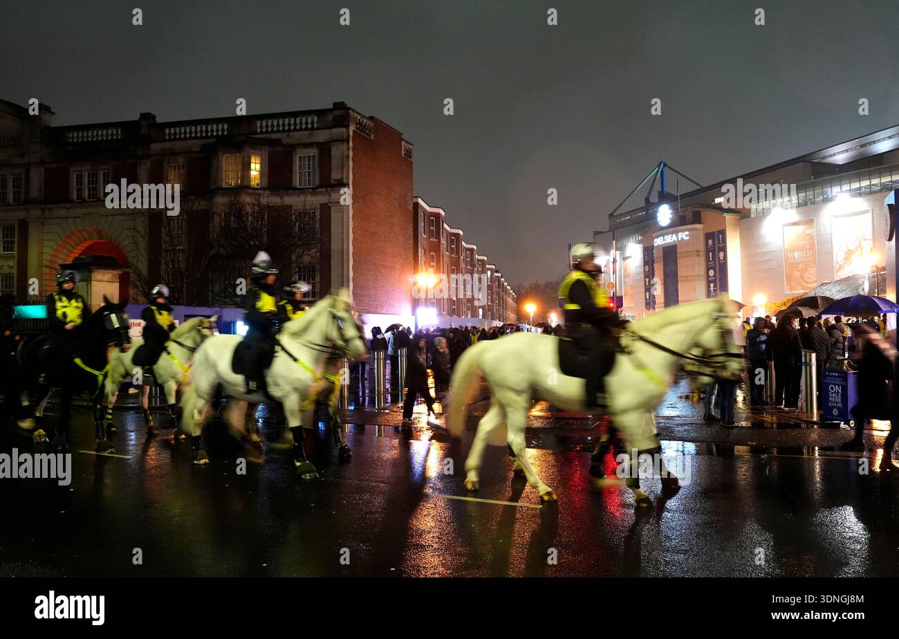 Mounted police officers ride past the stadium ahead of the Premier ...