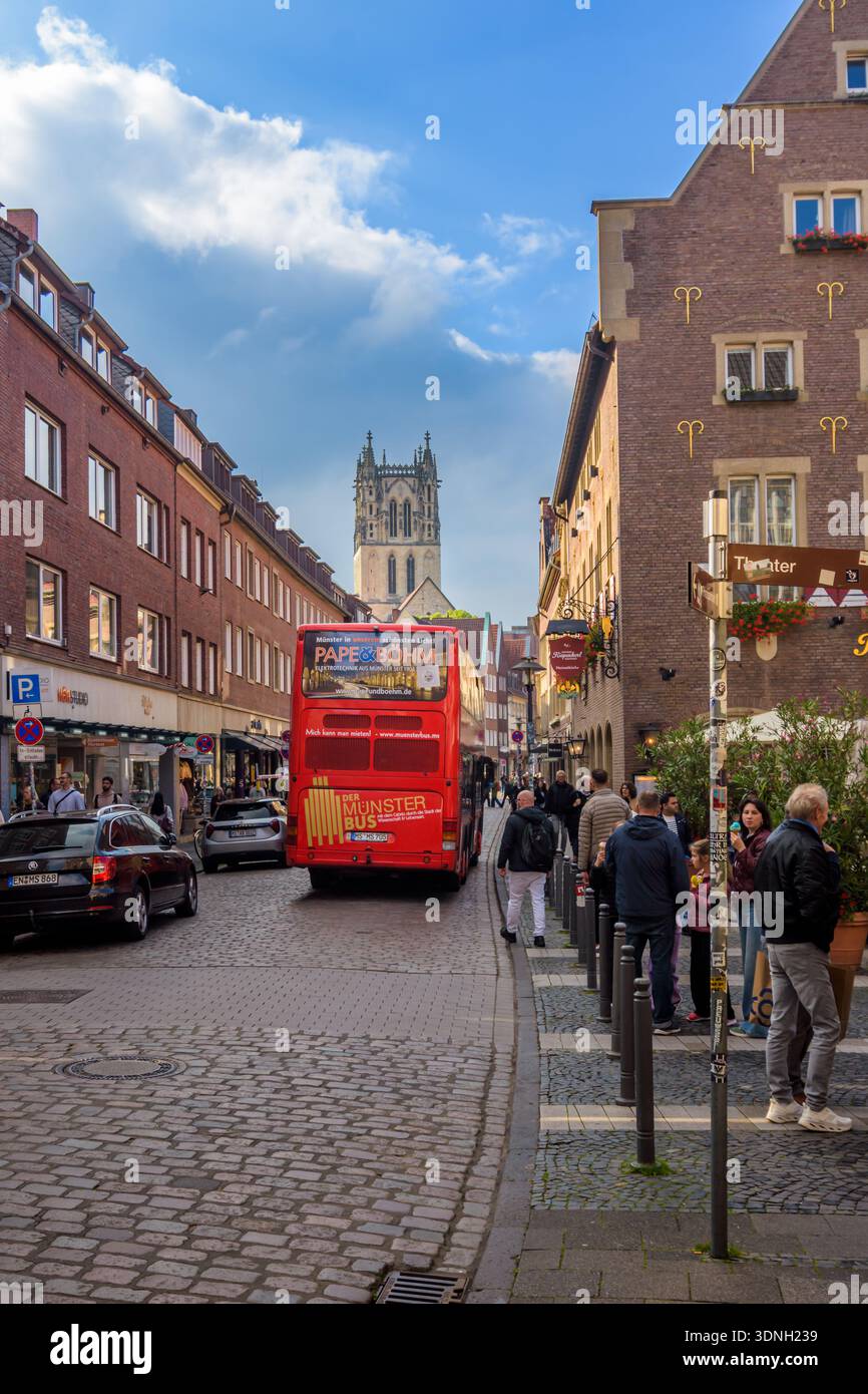 Hop on Hop off touris excursion bus at the old town street of Munster, Germany Stock Photo
