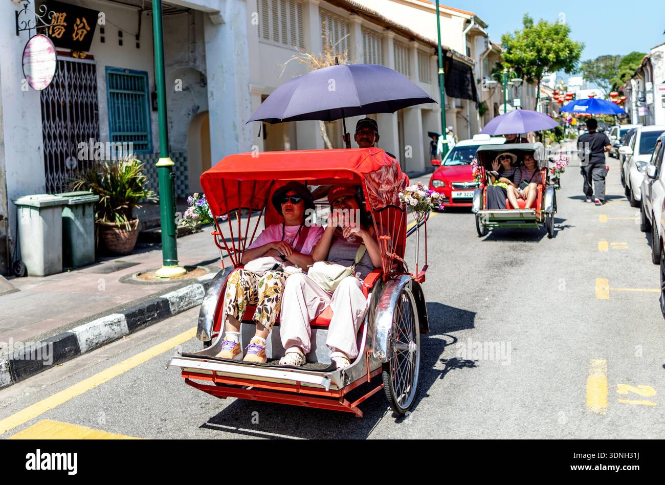 Tourists in a Rickshaw in Georgetown Penang Malaysia Stock Photo