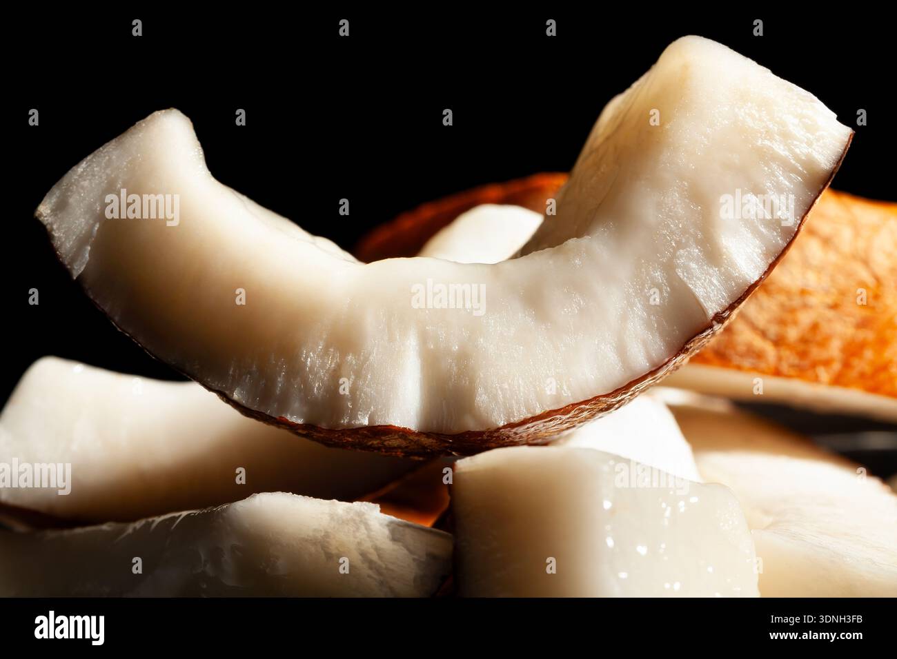 sliced coconut on black background Stock Photo