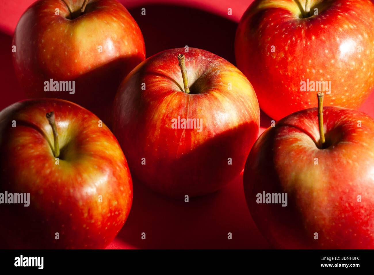 red apple on red background Stock Photo