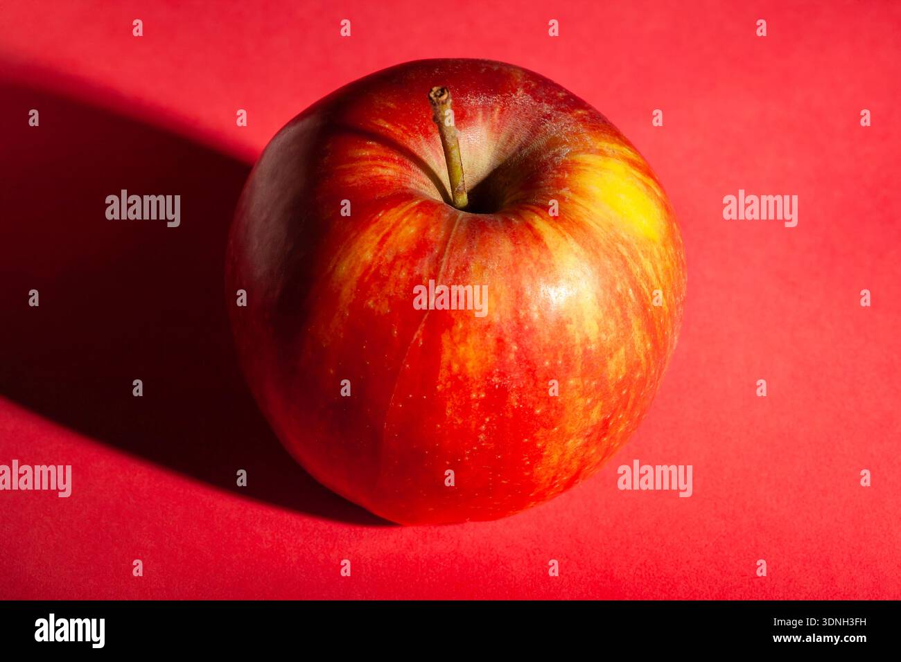 red apple on red background Stock Photo