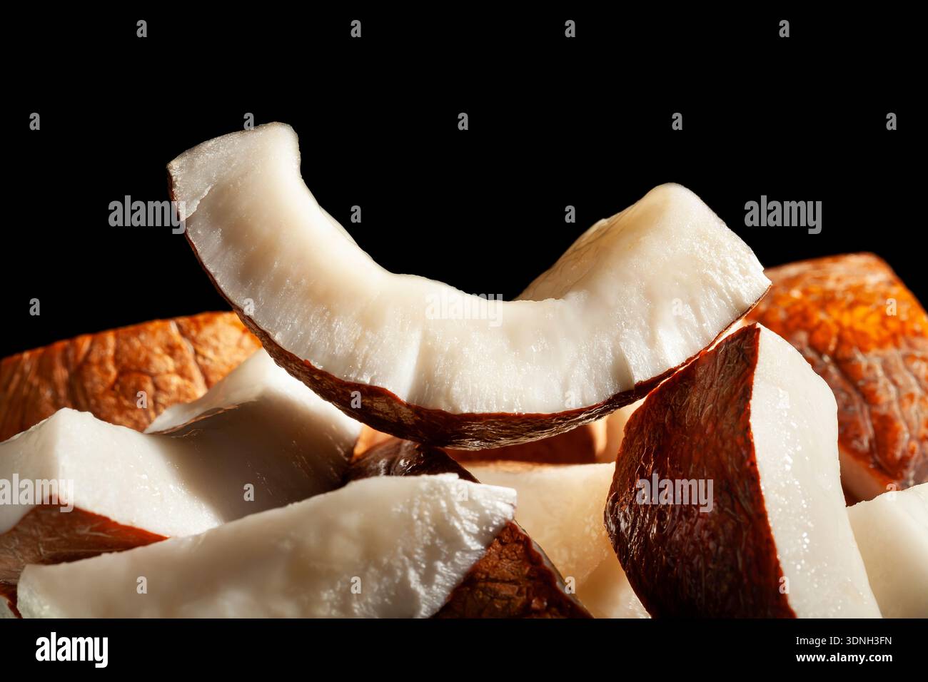 sliced coconut on black background Stock Photo