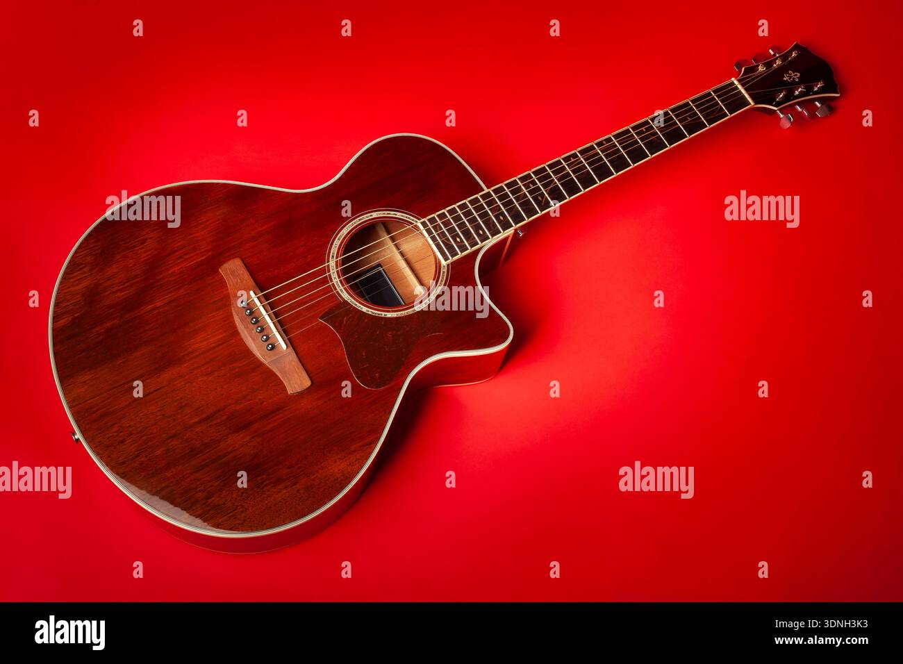 acoustic guitar on red background Stock Photo