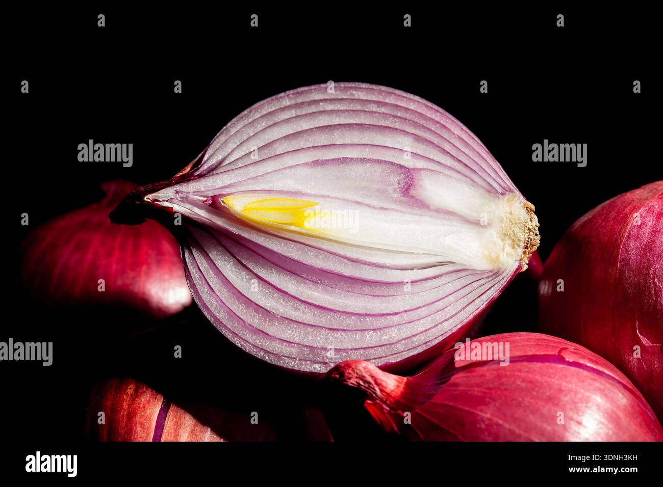 sliced red onion on black background Stock Photo