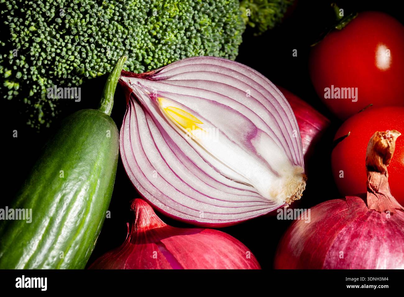 sliced red onion vegetable mix on black background Stock Photo