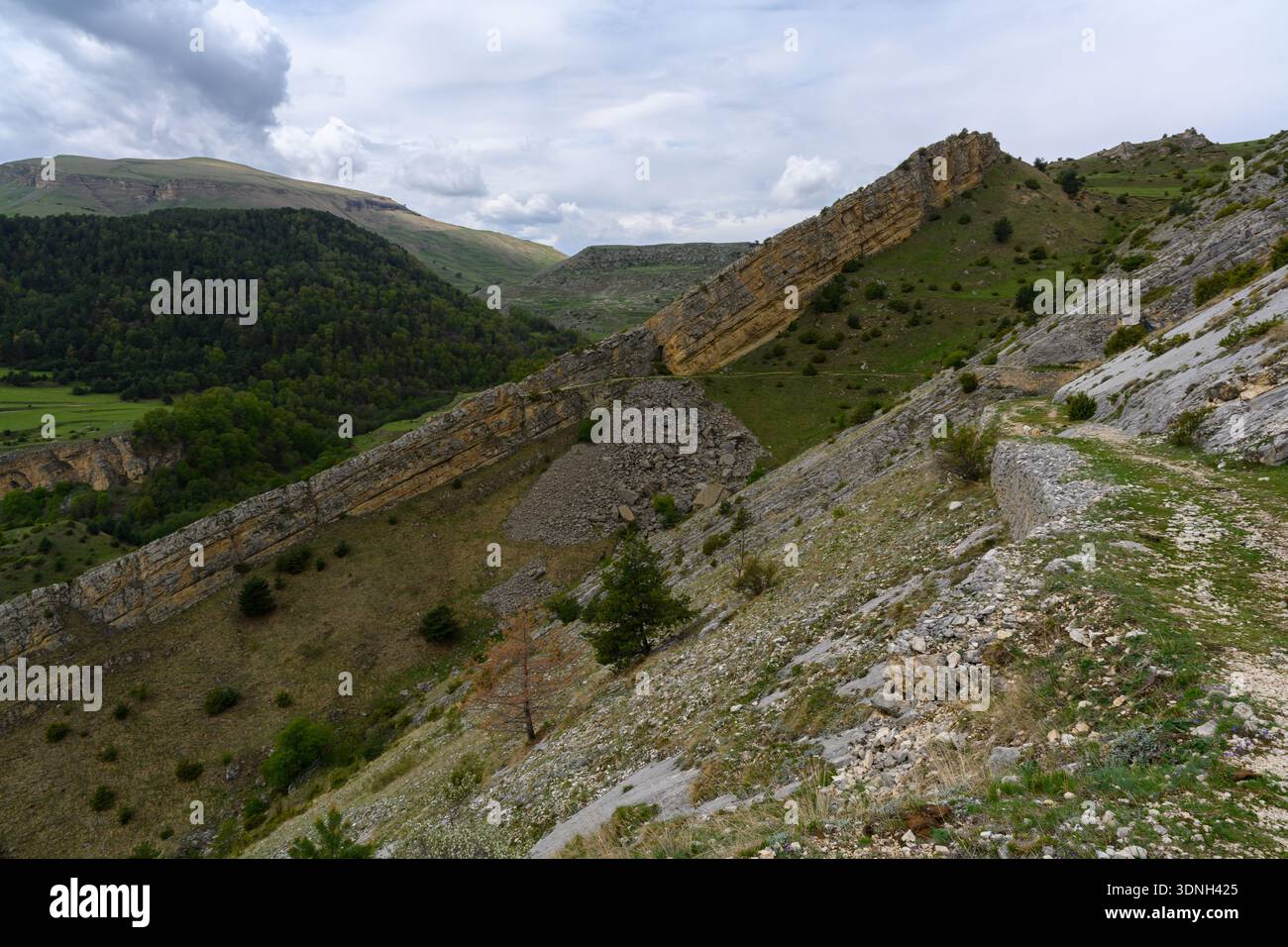 Dramatic Ridge Landscape Under Cloudy Sky Stock Photo