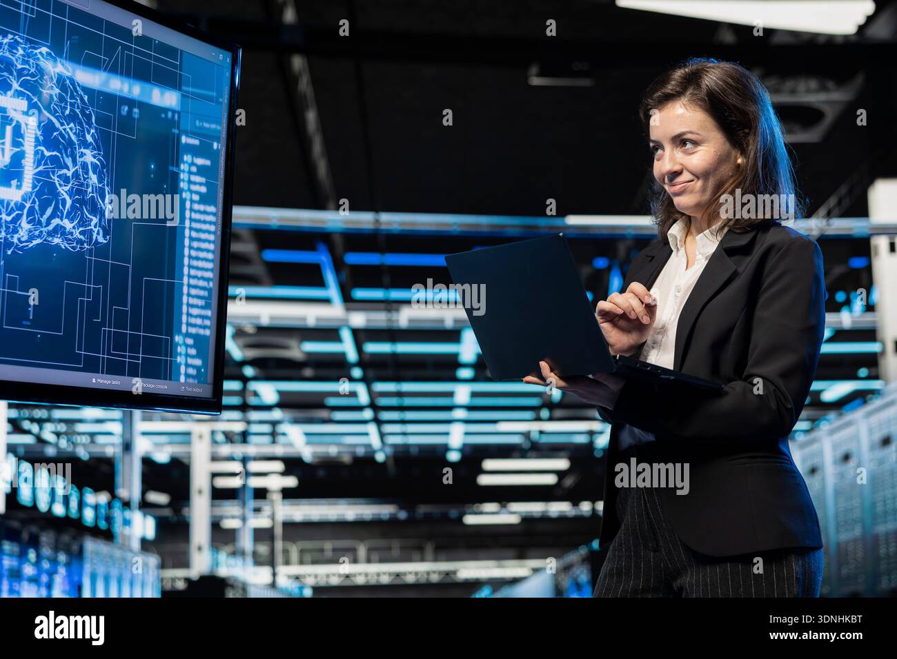 Jolly server room software developer using AI feeling happy by upgraded cloud storage gear increased performance. Smiling data center admin pleased by artificial intelligence processing large datasets Stock Photo