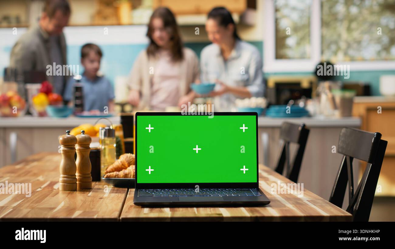 Green screen next to parents and kids having fun in the kitchen with ...