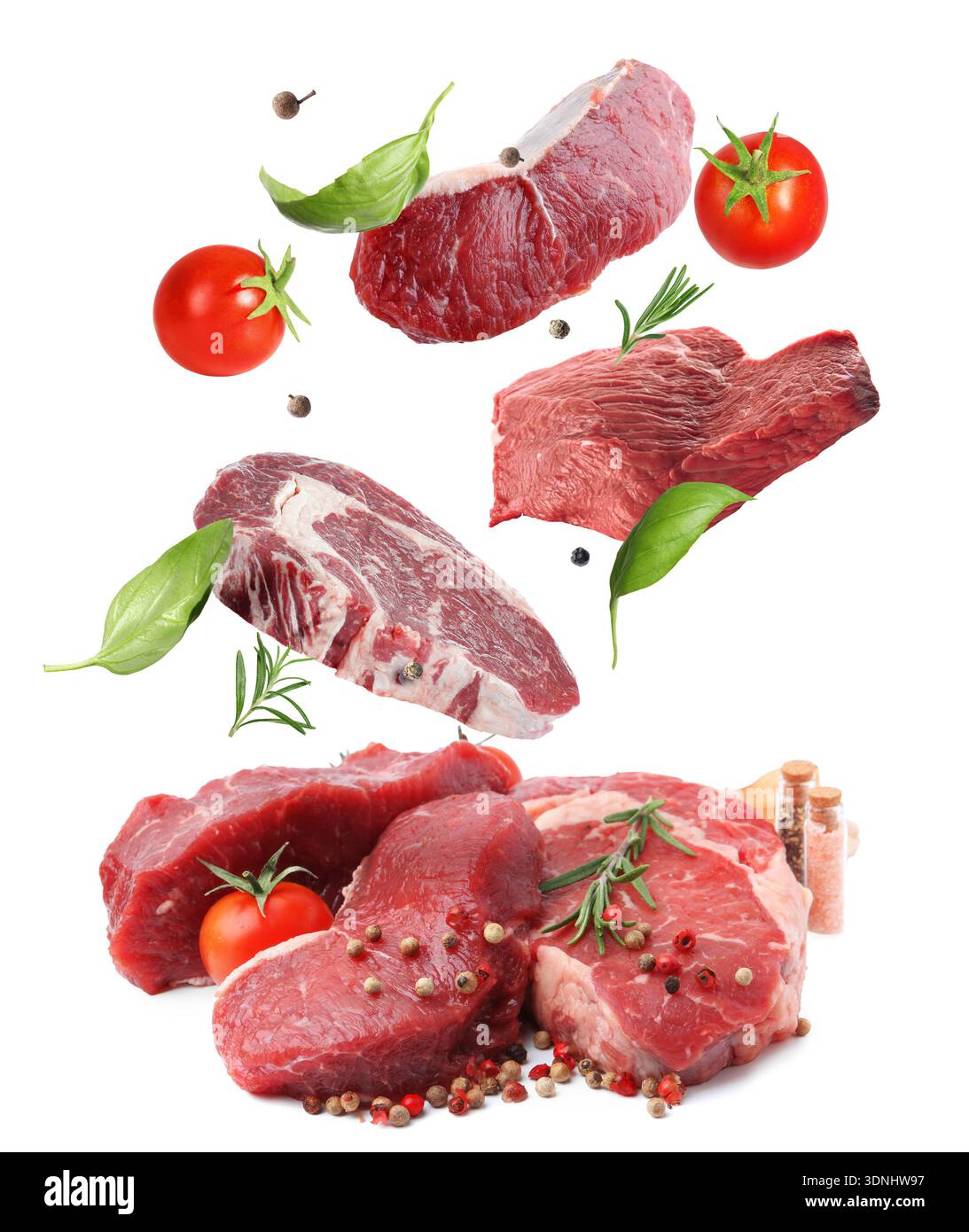 Fresh beef steaks falling on white background Stock Photo