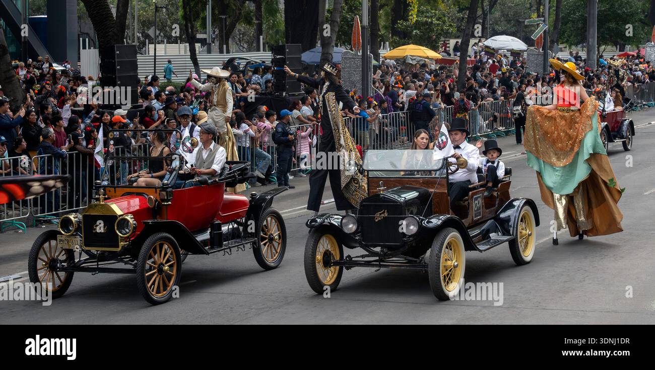 People in vintage cars and on stilts parade on the Day of the Dead in Mexico City, Mexico Stock Photo