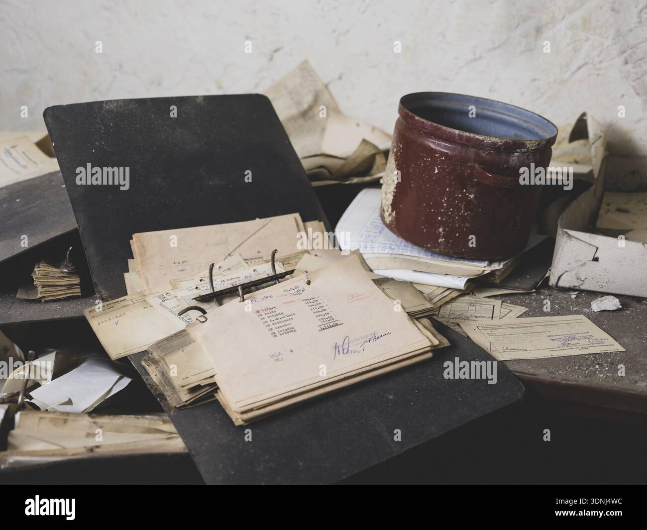 Folders, forms and an old pot on a table in a former GDR factory, Lost Place, Saxony-Anhalt, Germany Stock Photo