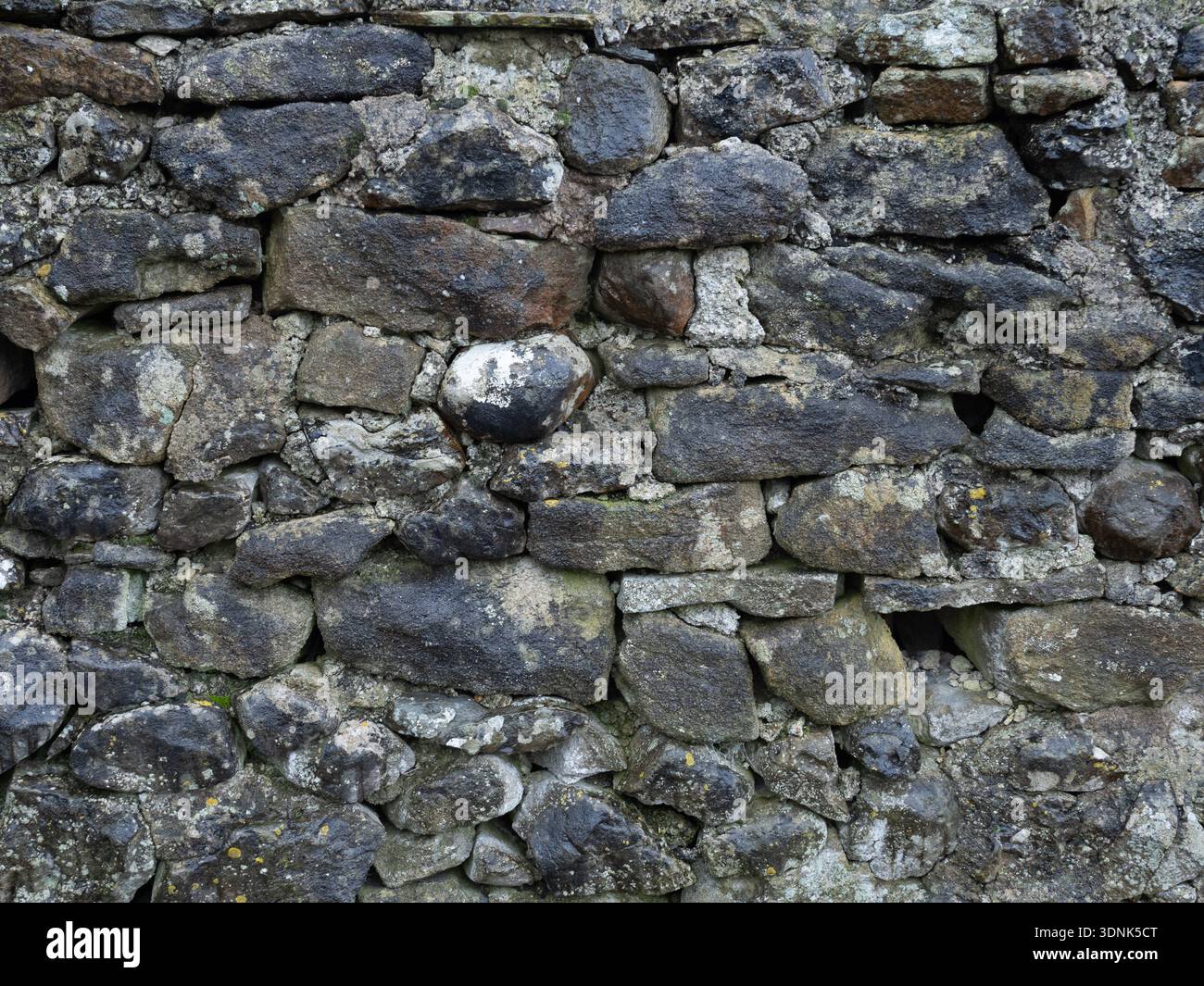 Historic Mineral stained dry stone wall Stock Photo