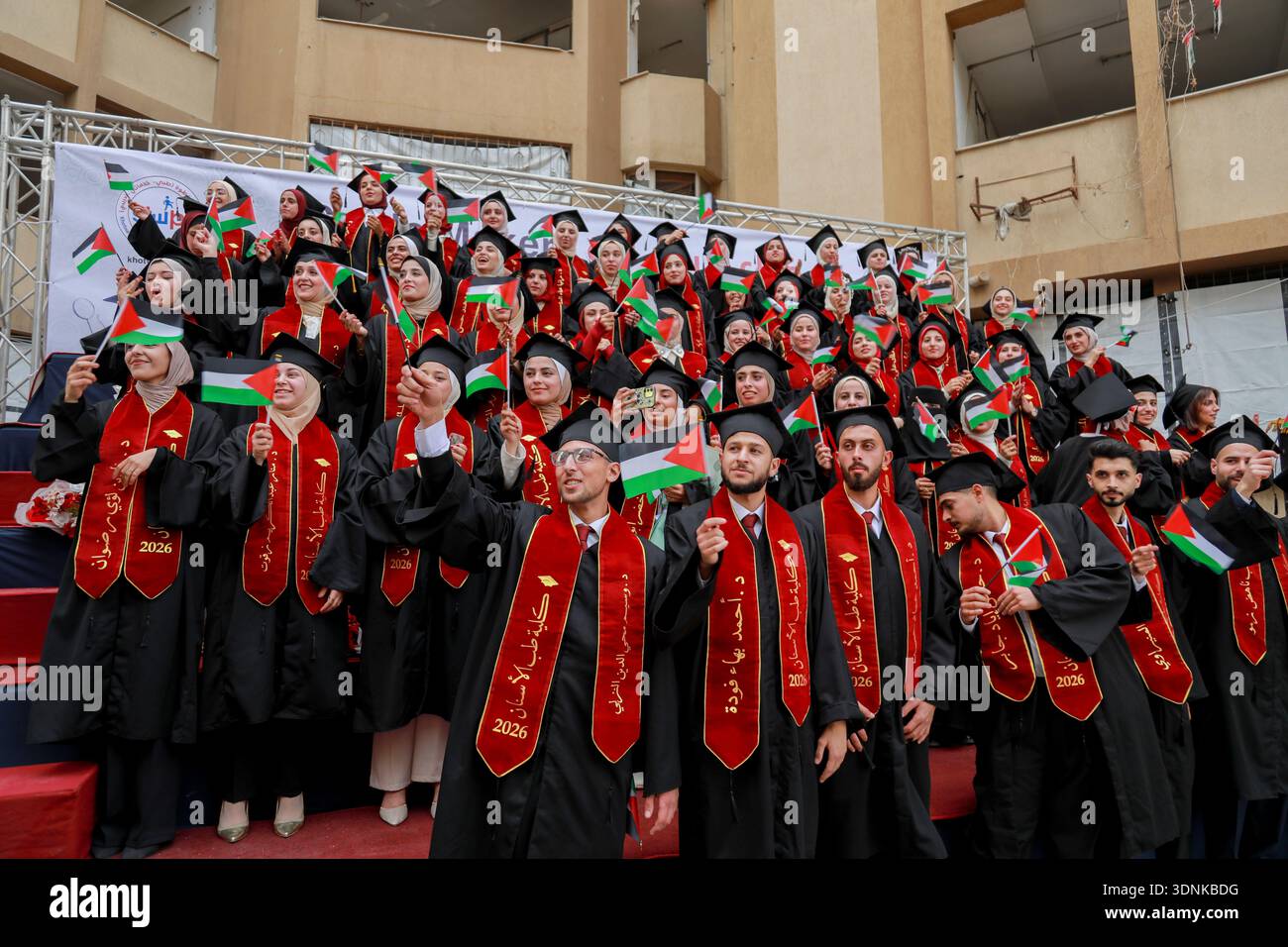 Graduates hold Palestinian flags as they stand during a graduation ...