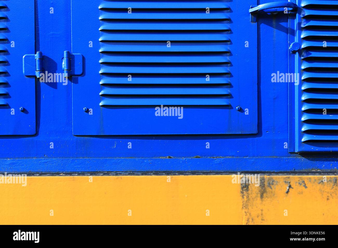Industrial Blue Panel with Vents and Yellow Base Stock Photo