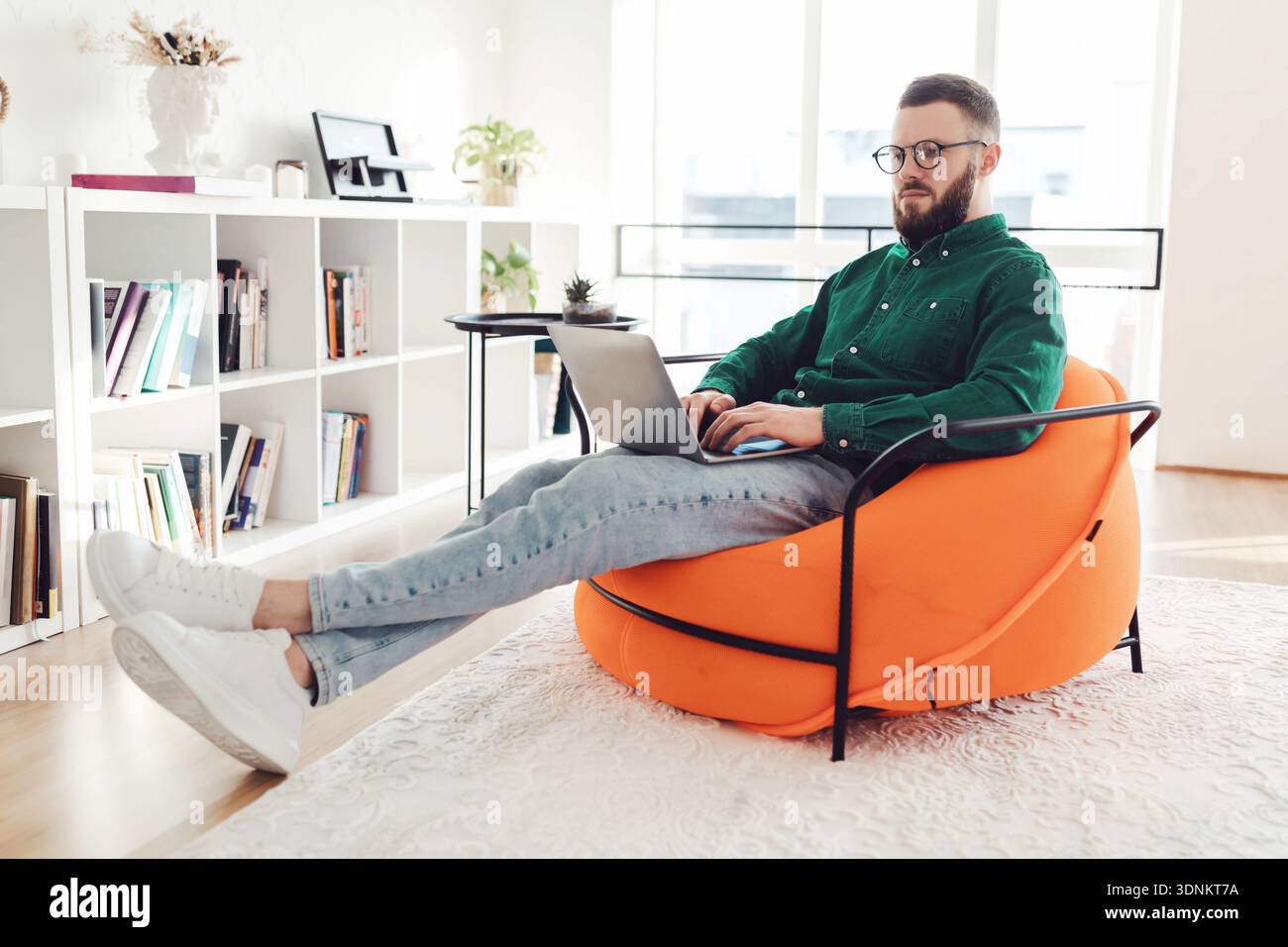 Freelancer Guy Using Laptop Working Online Browsing Internet Sitting Indoors Stock Photo