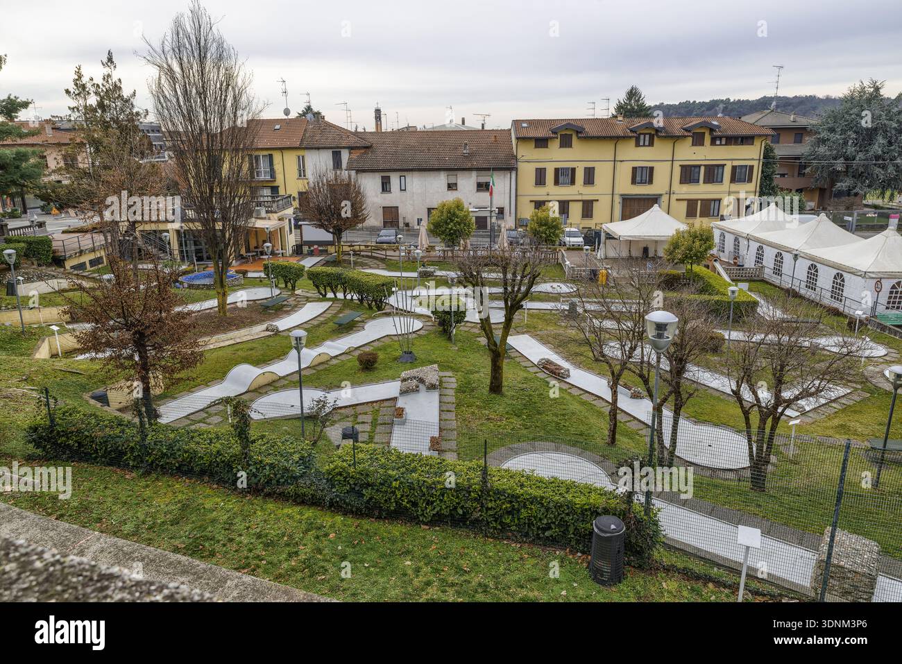 Overhead view of a empty miniature golf course in a green park environment, featuring various obstacles, under natural light. Vergiate town, Italy Stock Photo
