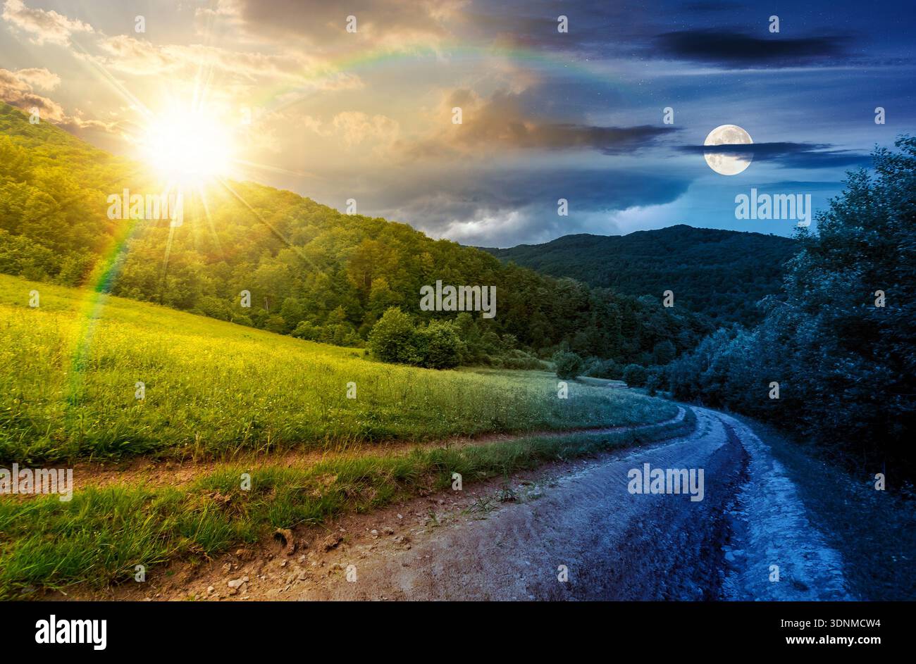 country road down the hill through the field. day and night time change concept. lovely countryside scenery of mountainous area on summer solstice wit Stock Photo