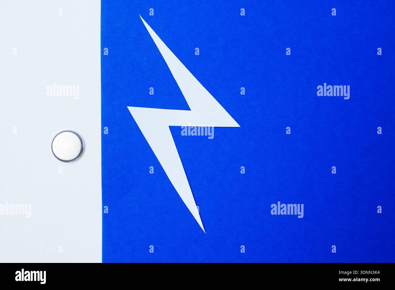 Tiny Blue Power Button Cell With Shiny Metal Edges Symbolizing Electronic Energy Flow Stock Photo
