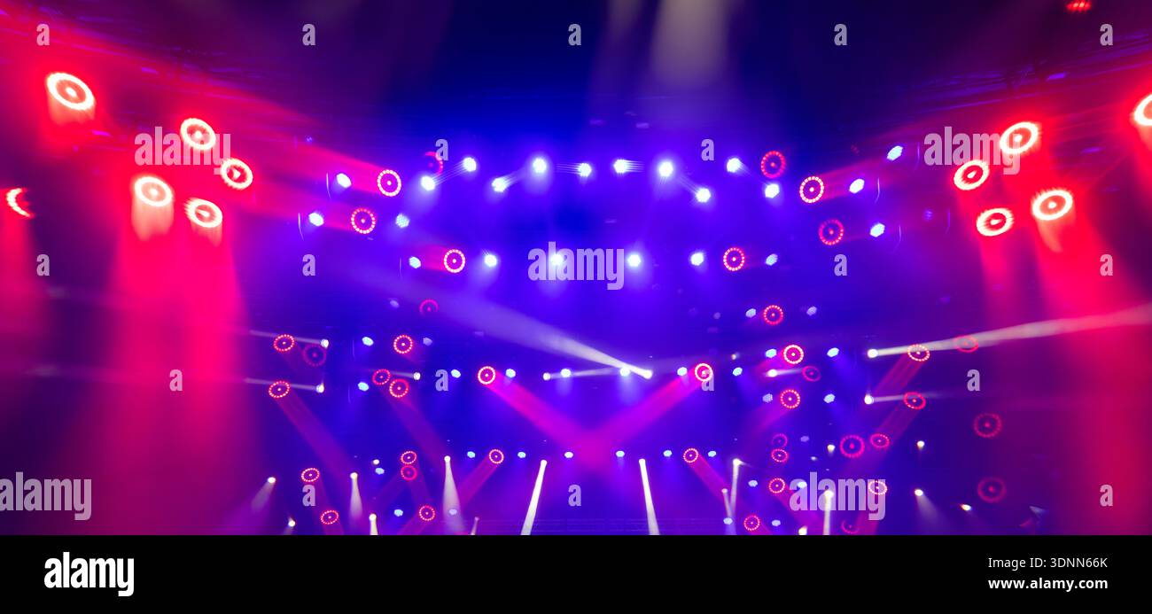 Dynamic Stage Lighting with Red and Blue Beams During Live Concert Performance Stock Photo