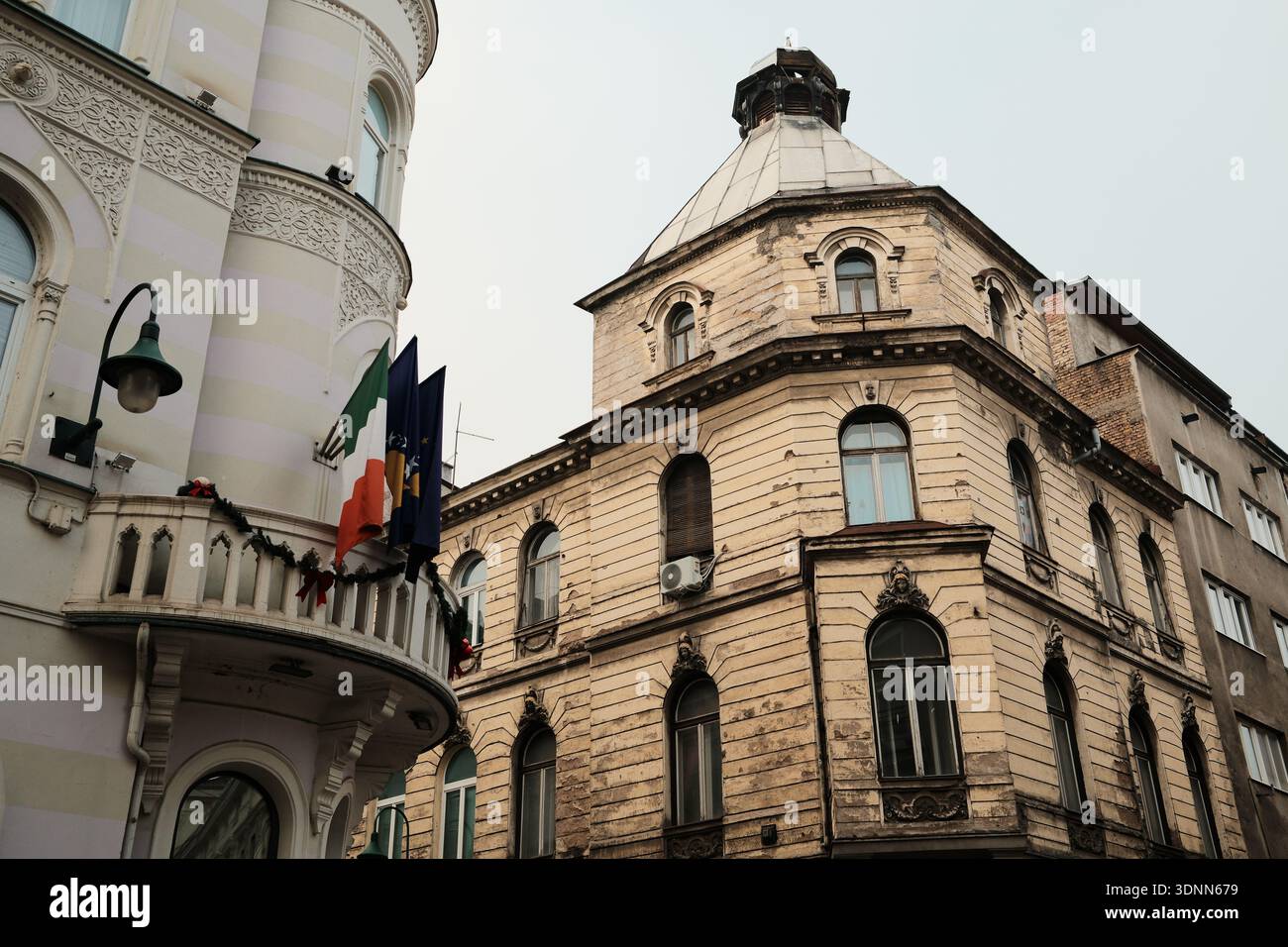 Historic corner buildings with ornate facades and domed roof in morning ...