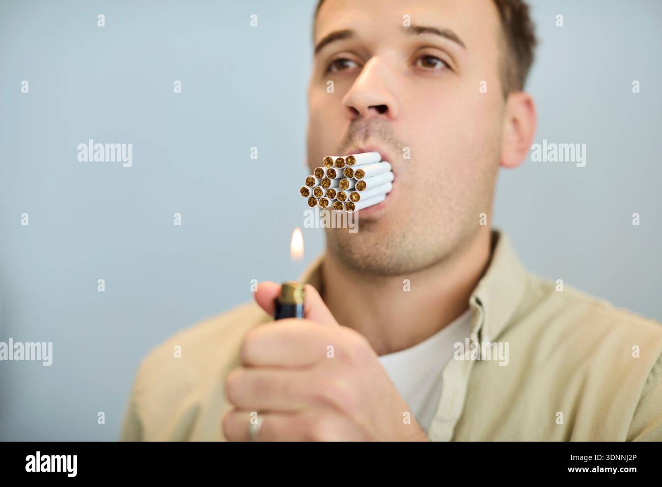 guy smoking multiple cigarettes Multiple cigarettes hi-res stock photography and images