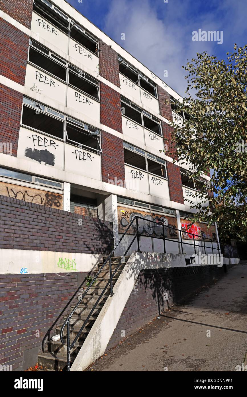 Vandalised and boarded up Victoria House office building on Wellington Street, Stockport, with repeated “FEER” graffiti on upper floors Stock Photo
