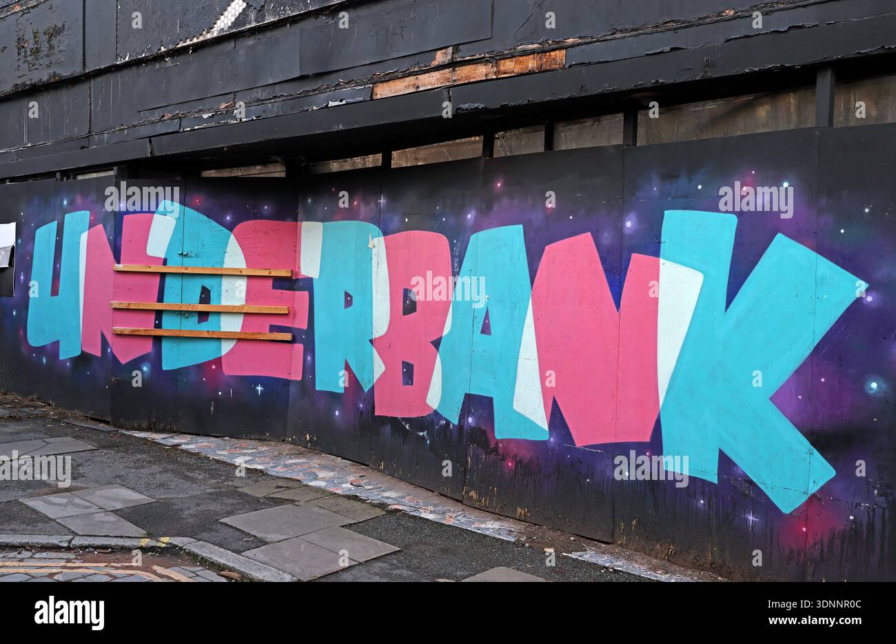 UNDERBANK street art mural on regeneration hoarding in Stockport town centre, marking the Underbanks area, Greater Manchester, England. Stock Photo