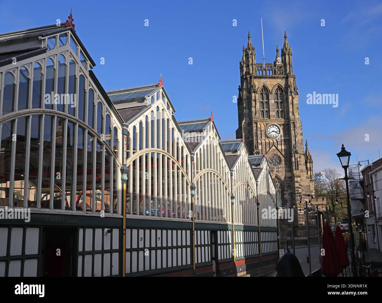 Stockport Market Hall and St Mary’s Church tower beside Market Place, Stockport town centre, Greater Manchester, in bright winter sunshine. Stock Photo