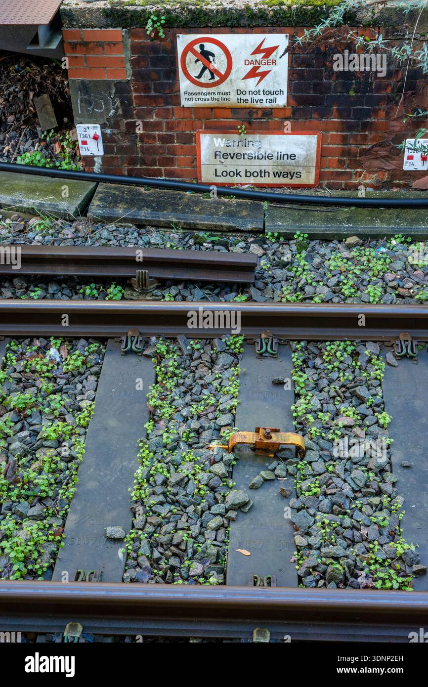 Side Rails Up Signs Warning signs at the side of the railway tracks at Brockenhurst station ...