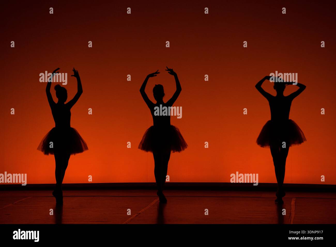 Ballet Dancers Silhouettes at Sunset Stage Stock Photo