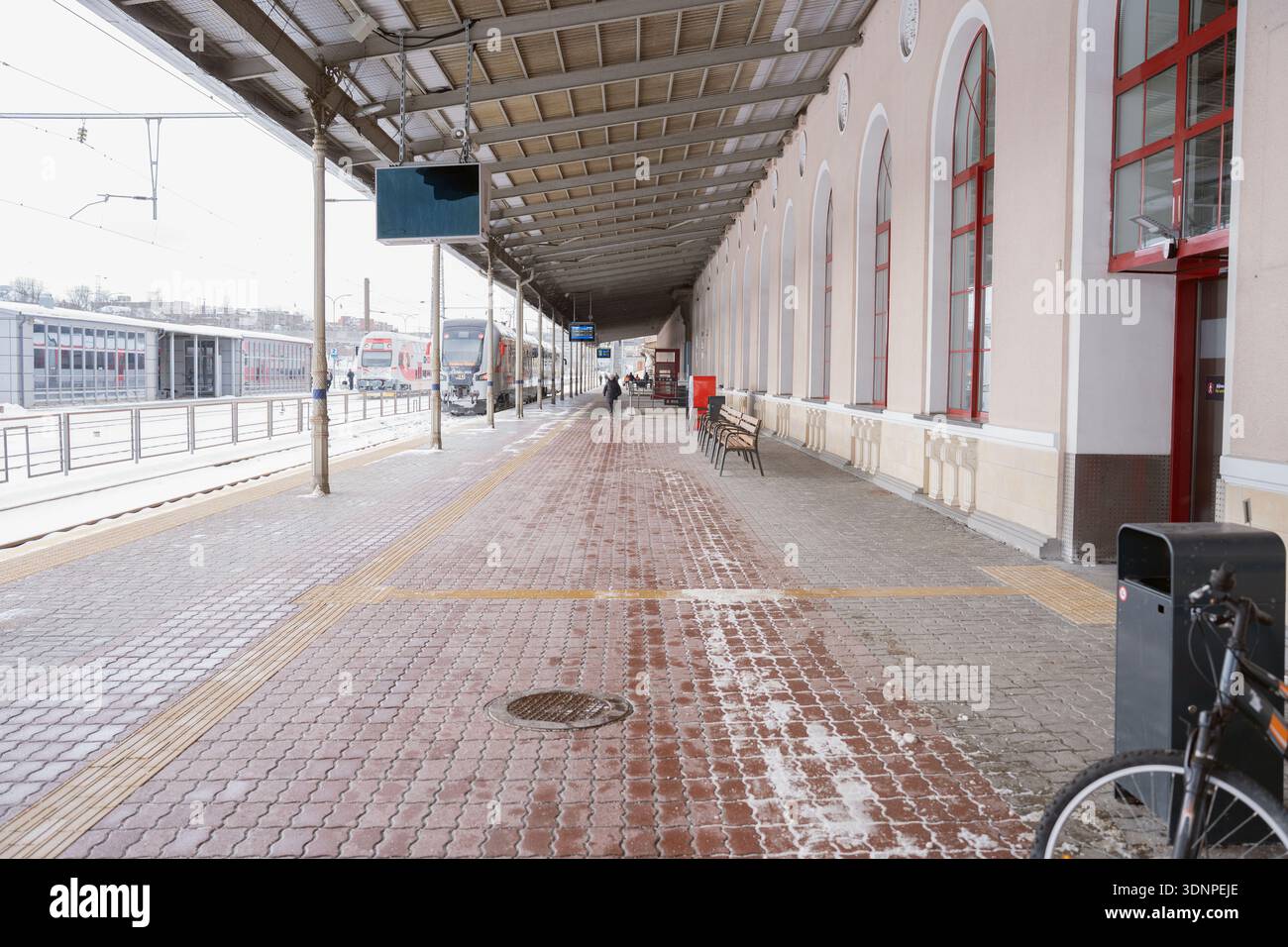 snow-dusted historic train station platform under a long metal canopy ...